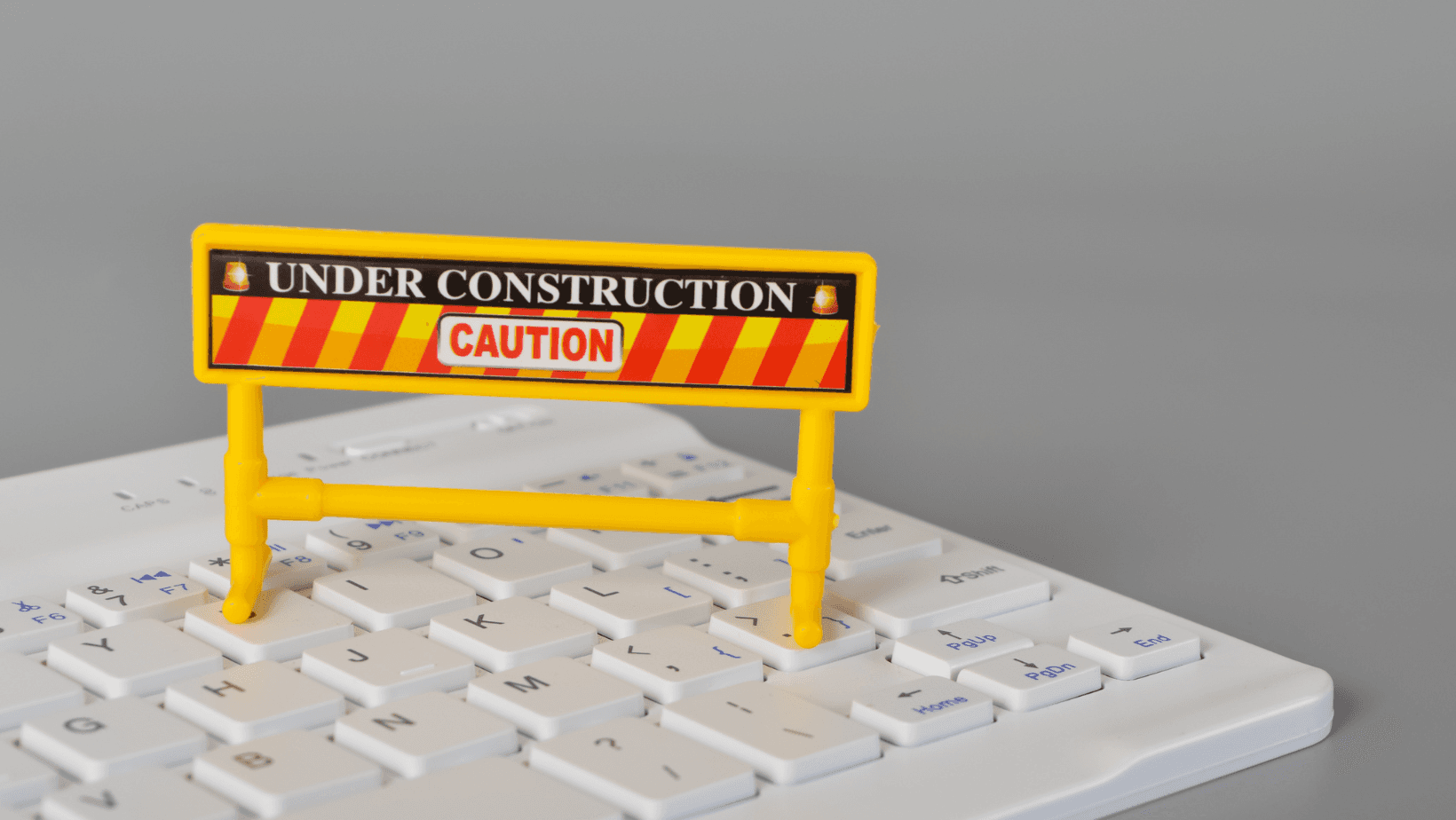 caution sign for construction on a computer keyboard
